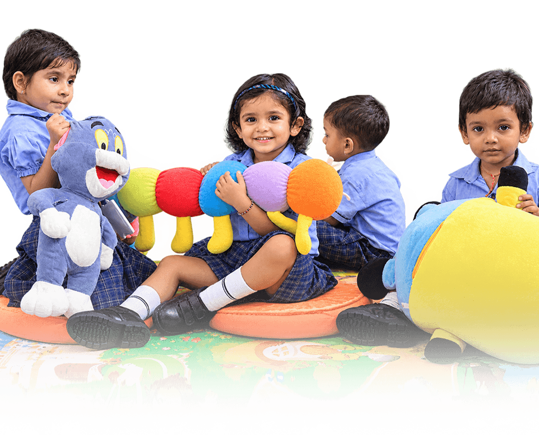 Junior Sri Sri Academy children playing with soft toys