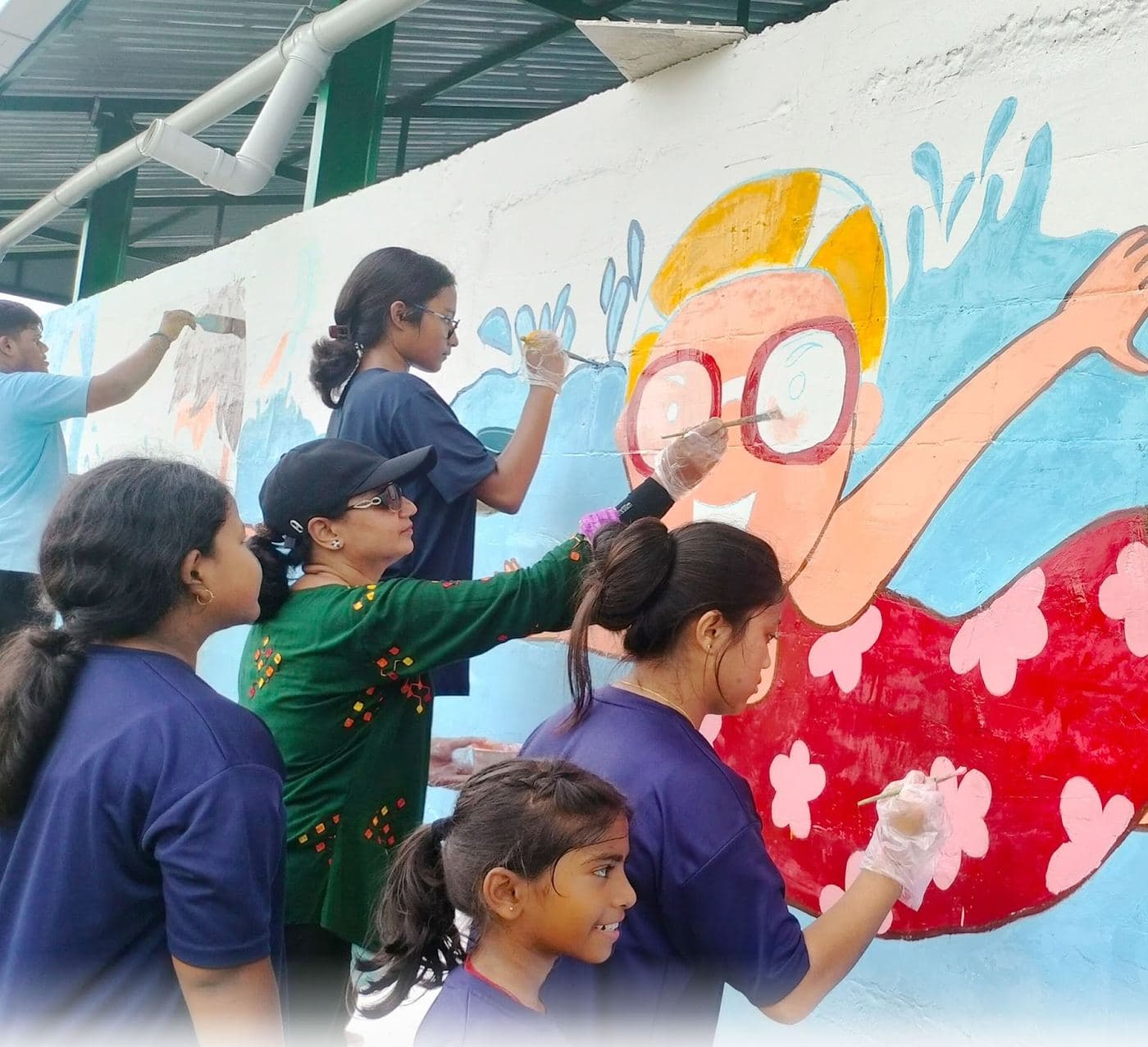 The mural team, all hands on the wall