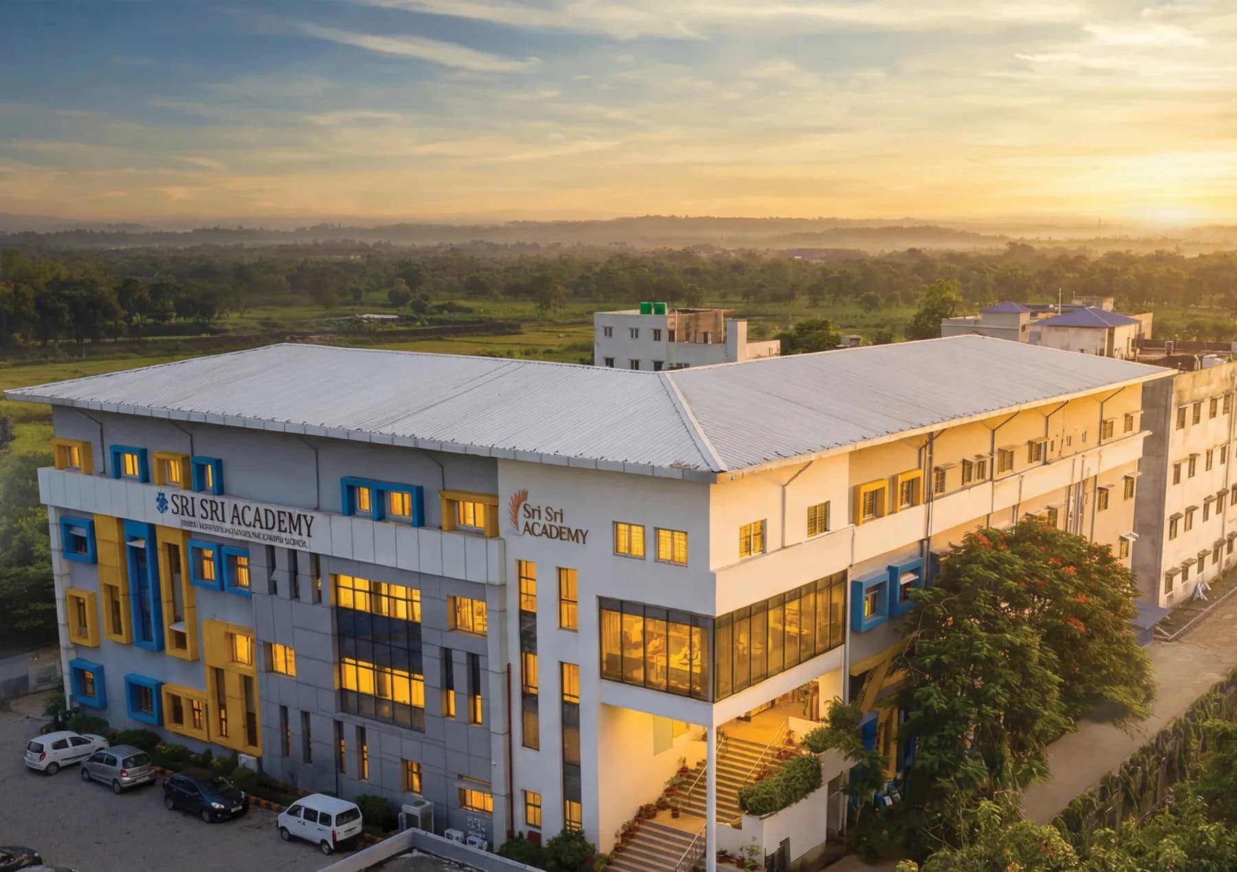 The Sri Sri Academy Siliguri campus building at sunrise