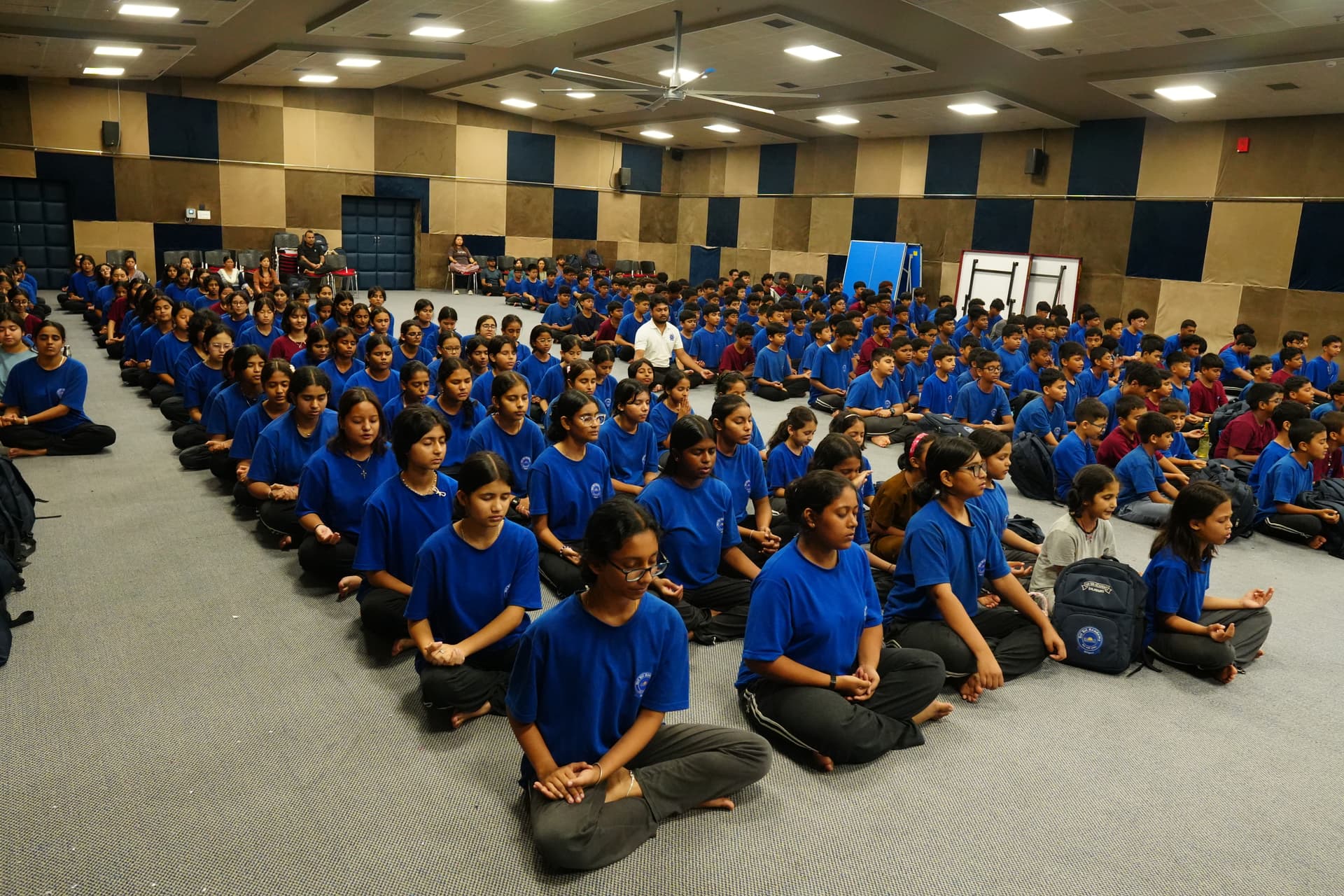 Sri Sri Academy students practising meditation together in the school auditorium