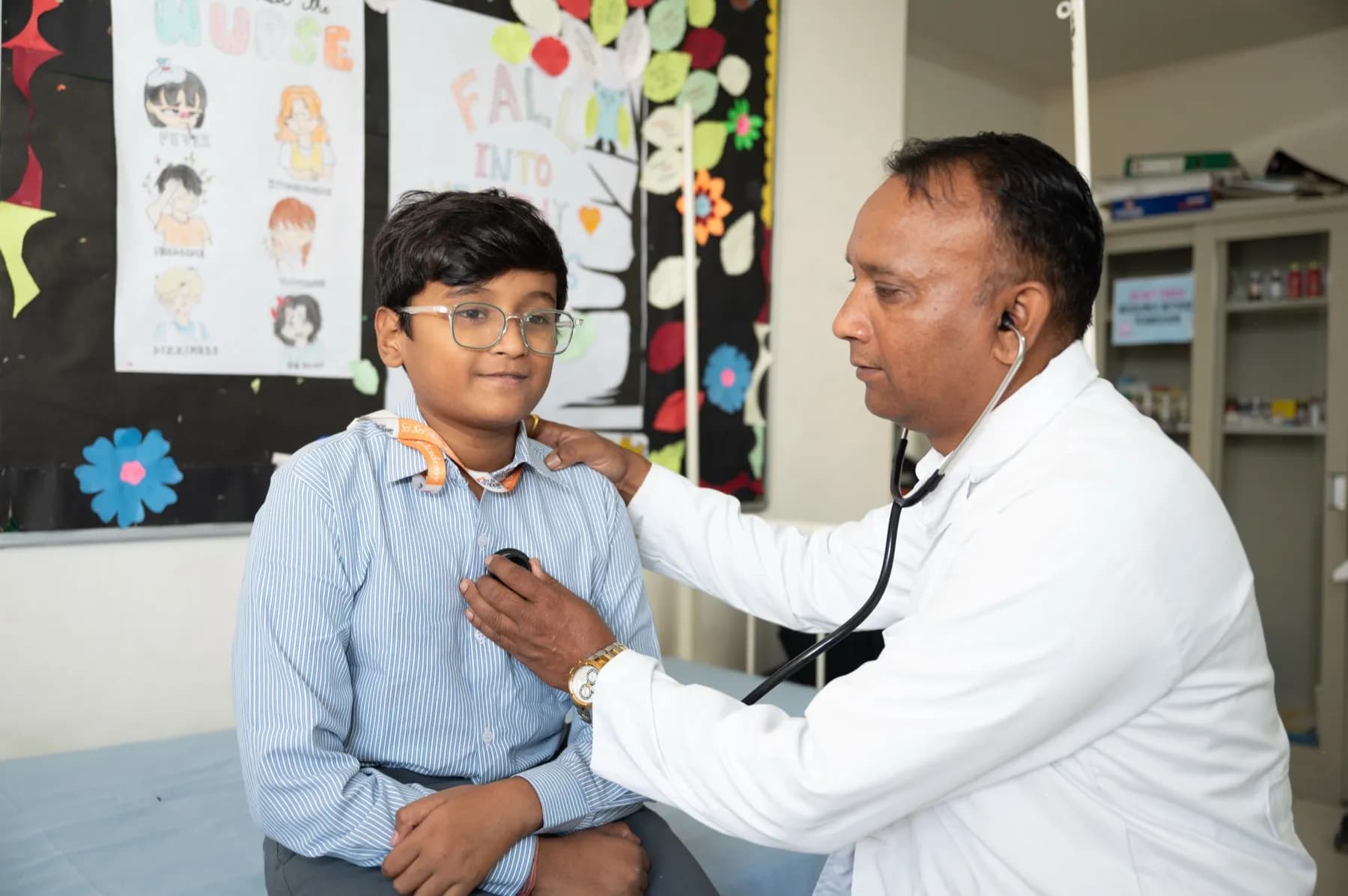 The campus doctor examining a student in the infirmary