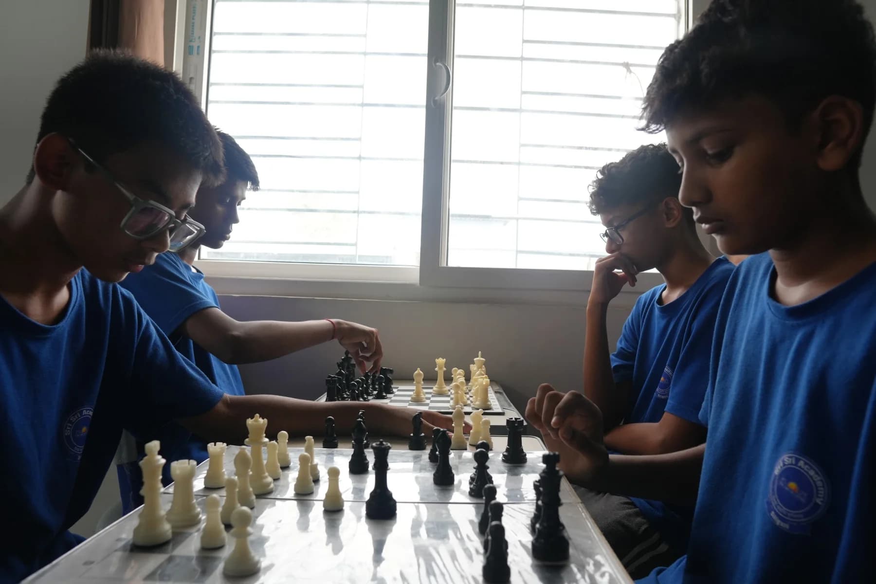 Boarders playing chess together at Sri Sri Academy