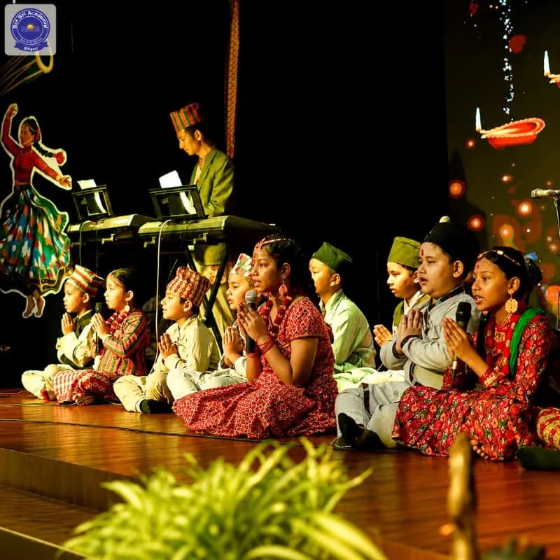 Students performing on stage at a Sri Sri Academy celebration